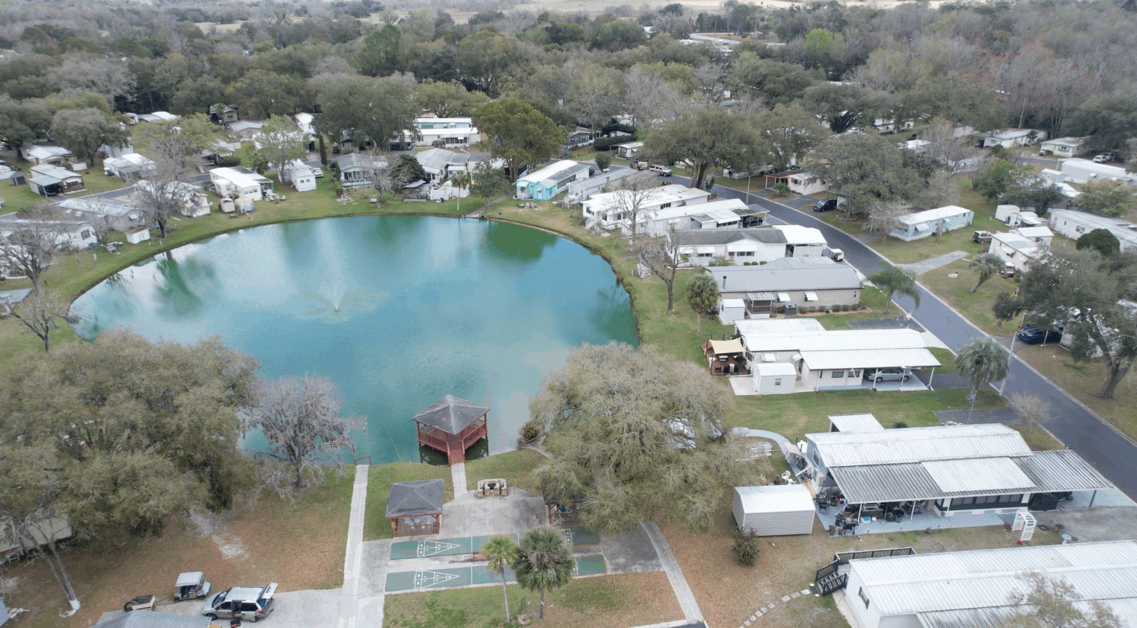 Aerial view of 3 Seasons Mobile Home Park and its pond